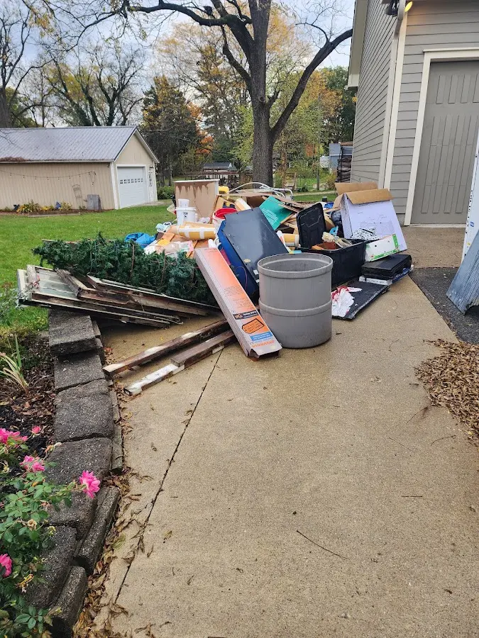 Dumpster being loaded with debris for Estate Cleanout Dumpster Rental in DeCordova
